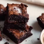 Delicious espresso brownies on a wooden table with coffee beans